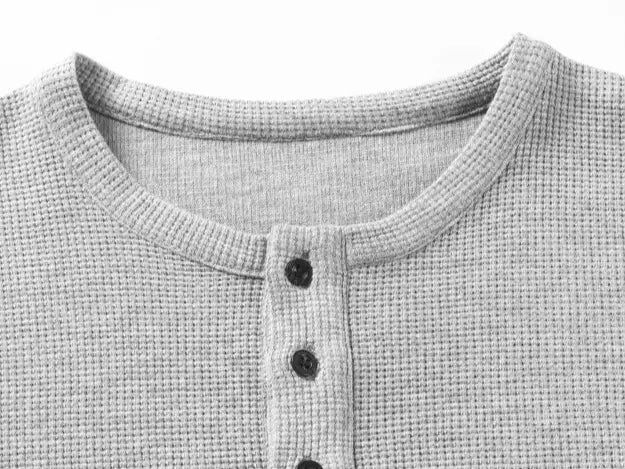 Men’s waffle-knit Henley-collar T-shirt featuring a half-button placket and small stand collar design, breathable textured knit fabric, relaxed drop-shoulder fit, solid color basic top for everyday casual wear.