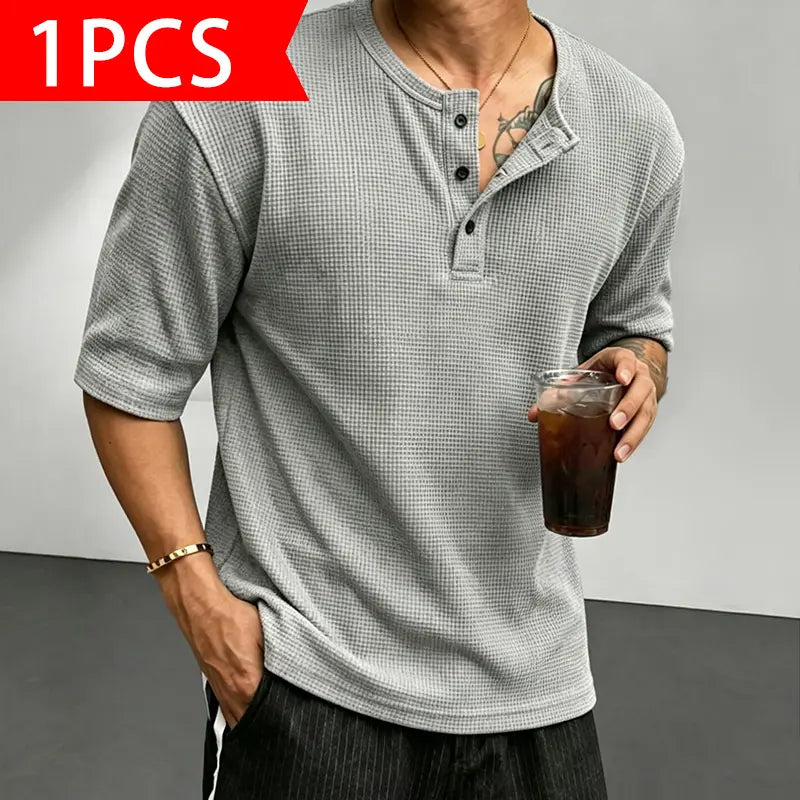 Men’s waffle-knit Henley-collar T-shirt featuring a half-button placket and small stand collar design, breathable textured knit fabric, relaxed drop-shoulder fit, solid color basic top for everyday casual wear.
