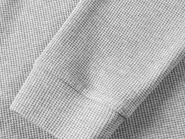 Men’s waffle-knit Henley-collar T-shirt featuring a half-button placket and small stand collar design, breathable textured knit fabric, relaxed drop-shoulder fit, solid color basic top for everyday casual wear.